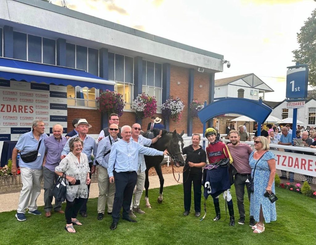 Syndicate members at Windsor with jockey Billy Lougnane after Calibos won